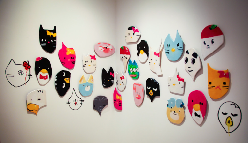 Shot of 29 Anthony Lister Masks hanging on wall at the Sanrio Small Gift Miami exhibit in 2010.